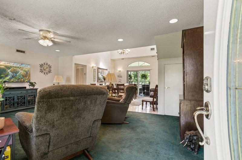 173 Stokes Landing Road St. Augustine, FL 32095 - Photo 15 of 71 a living room with furniture and a gym machine