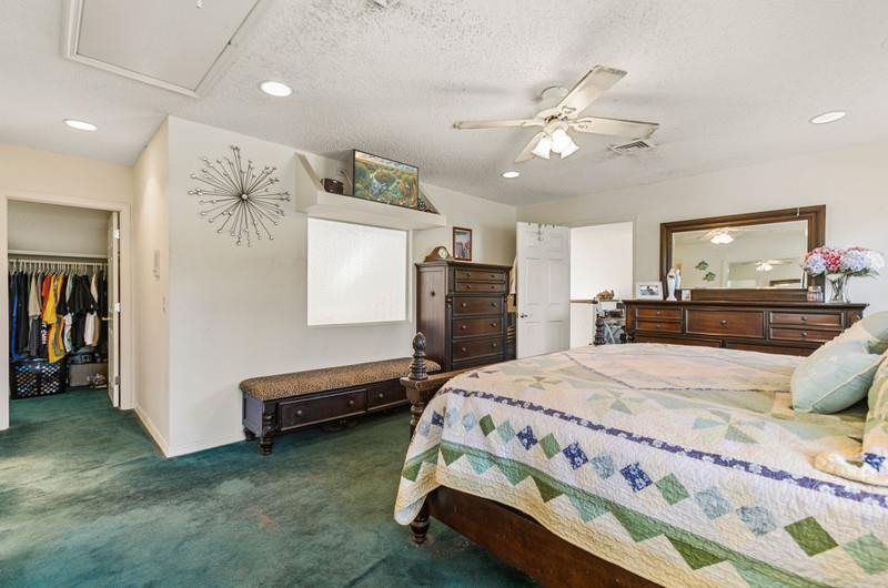 173 Stokes Landing Road St. Augustine, FL 32095 - Photo 17 of 71 a bedroom with a bed and a chandelier