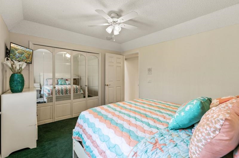173 Stokes Landing Road St. Augustine, FL 32095 - Photo 18 of 71 a bedroom with a large bed and a chandelier