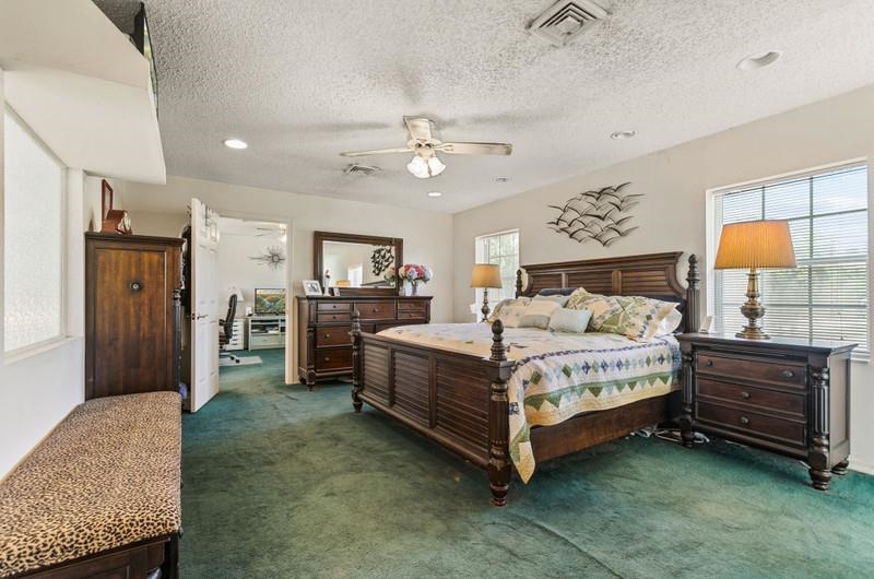 173 Stokes Landing Road St. Augustine, FL 32095 - Photo 25 of 71 a spacious bedroom with a bed and a dresser
