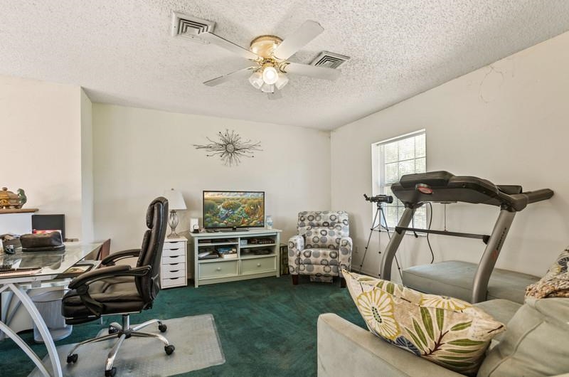 173 Stokes Landing Road St. Augustine, FL 32095 - Photo 30 of 71 a workspace with furniture and a chandelier fan