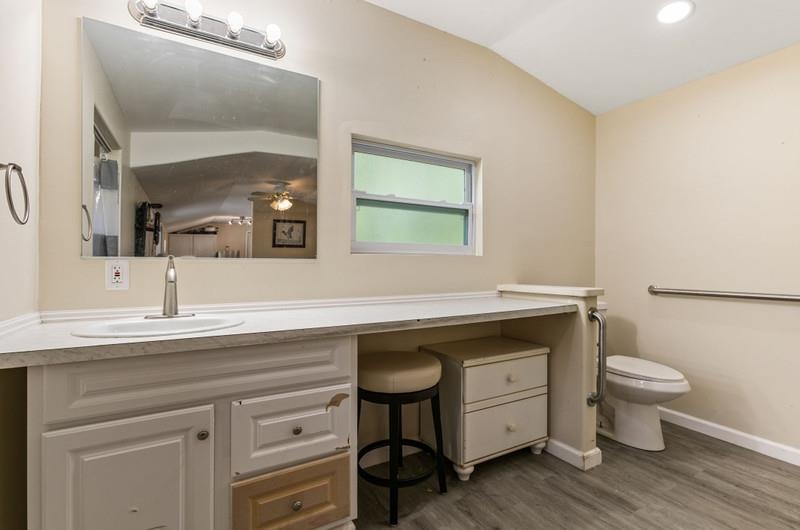 173 Stokes Landing Road St. Augustine, FL 32095 - Photo 39 of 71 a spacious bathroom with a granite countertop sink a toilet and a mirror