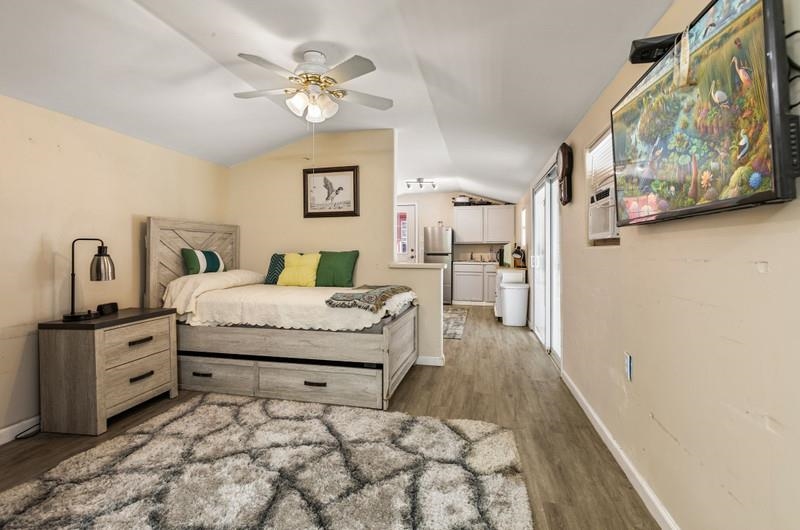 173 Stokes Landing Road St. Augustine, FL 32095 - Photo 41 of 71 a bedroom with a bed and a chandelier