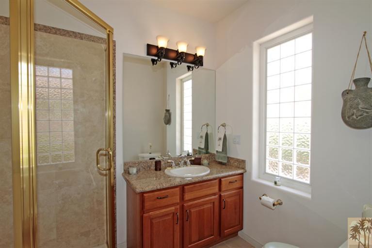 79175 Bermuda Dunes Drive Bermuda Dunes, CA 92203 - Photo 13 of 21 a bathroom with a double vanity sink a mirror and a shower