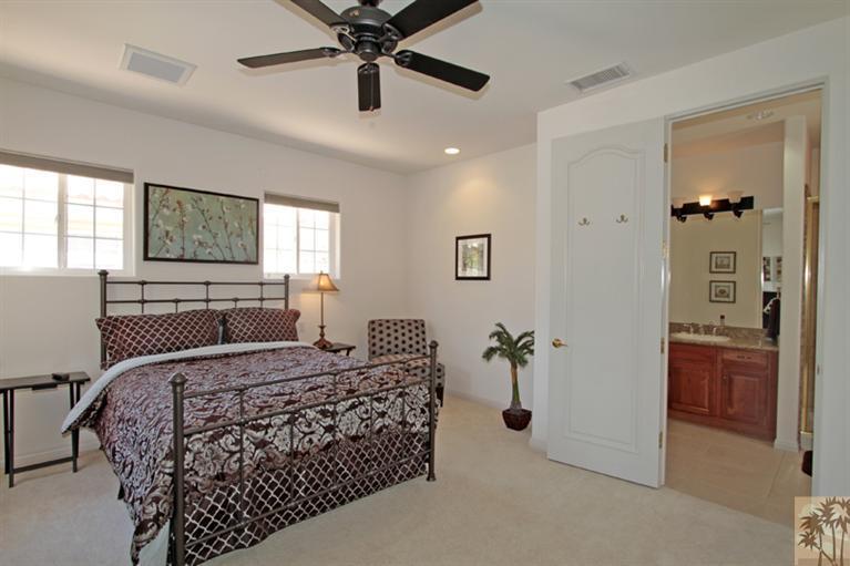 79175 Bermuda Dunes Drive Bermuda Dunes, CA 92203 - Photo 14 of 21 a bedroom with a bed and a chandelier