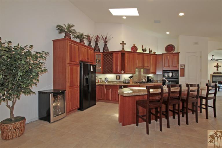 79175 Bermuda Dunes Drive Bermuda Dunes, CA 92203 - Photo 7 of 21 a kitchen with stainless steel appliances lots of wooden furniture
