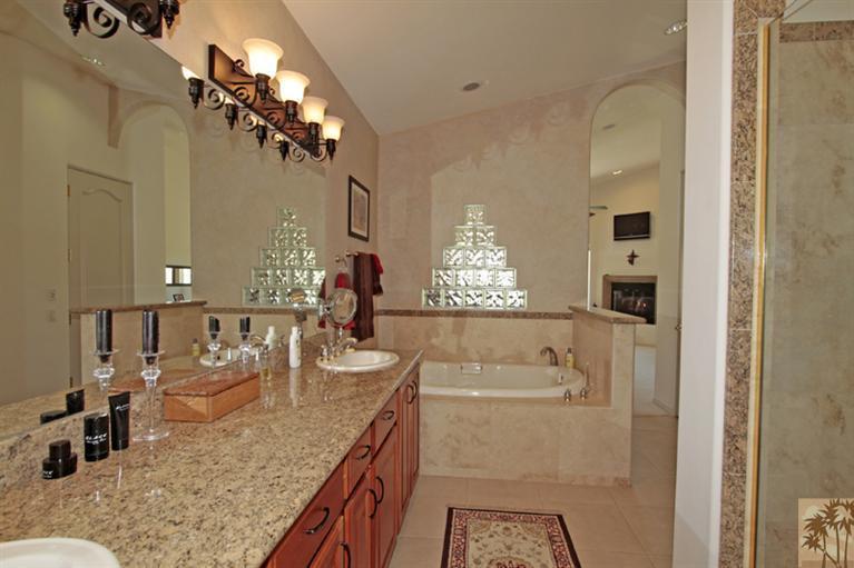 79175 Bermuda Dunes Drive Bermuda Dunes, CA 92203 - Photo 10 of 21 a bathroom with a granite countertop sink a mirror and shower