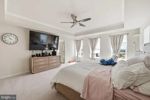 a bedroom with a large bed and a flat screen tv