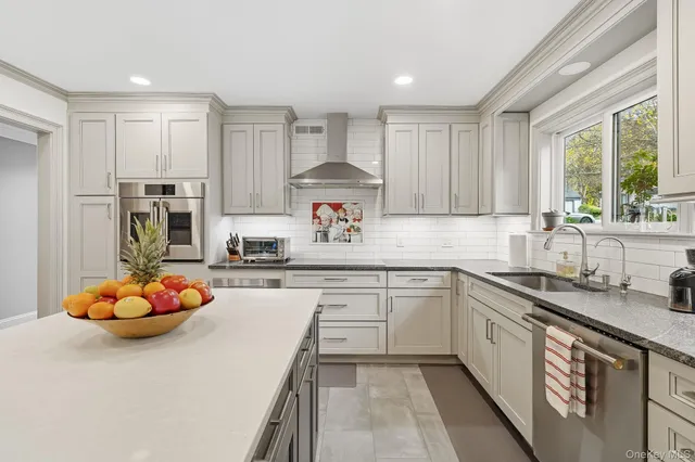 a kitchen with stainless steel appliances granite countertop a sink stove and cabinets