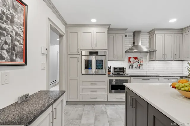 a kitchen with granite countertop stainless steel appliances and wooden cabinets