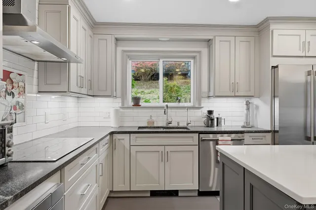 a kitchen with a sink stove and cabinets