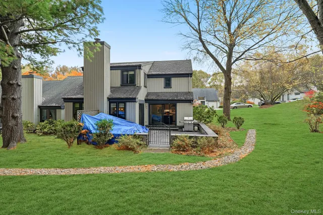 a view of a house with swimming pool and yard