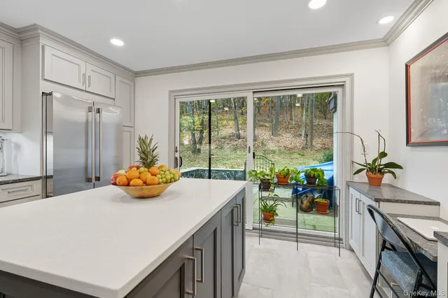 a kitchen with sink and refrigerator