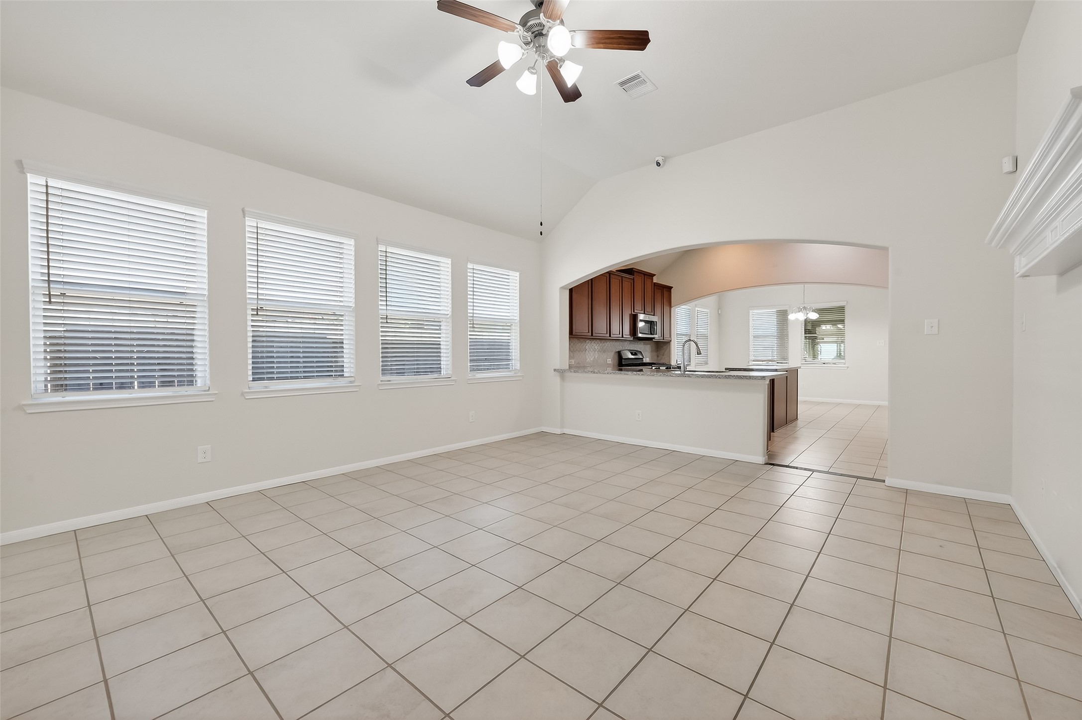7631 Granite Terrace Lane Houston, TX 77083 - Photo 7 of 46 a view of an empty room with a window and kitchen view