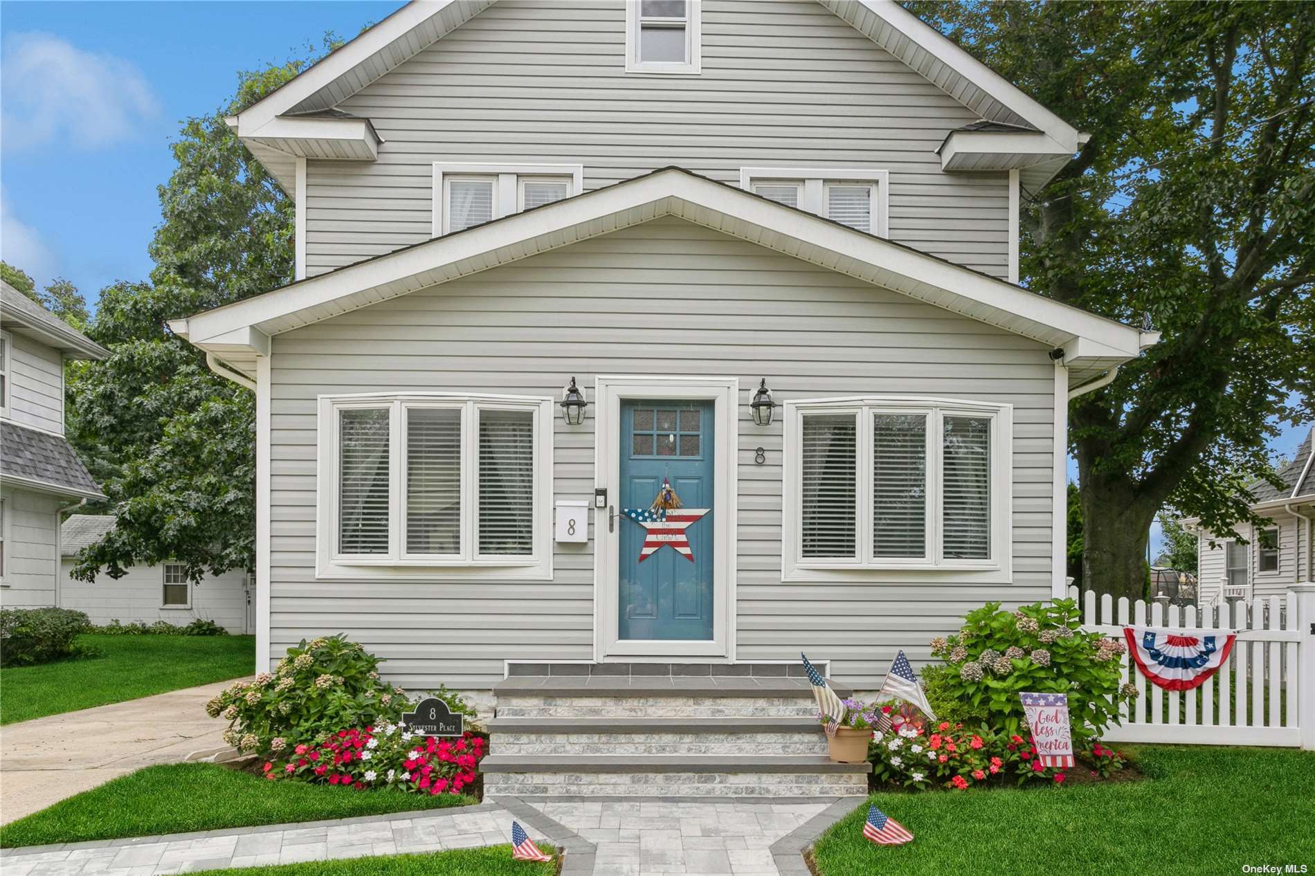 8 Sylvester Place Lynbrook, NY 11563 - Photo 1 of 24 a front view of a house with garden