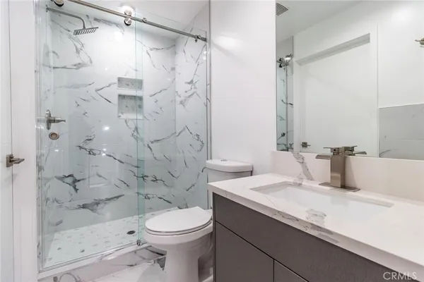 a bathroom with a sink toilet and shower