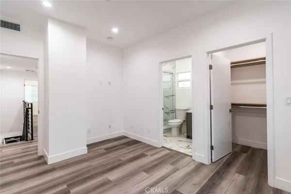 a bathroom with a granite countertop toilet and a shower