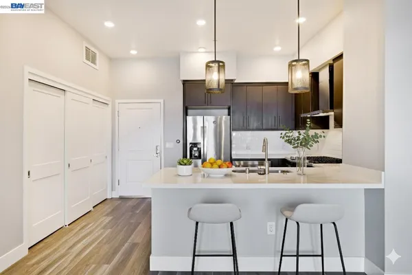 a kitchen with stainless steel appliances kitchen island granite countertop a sink and cabinets