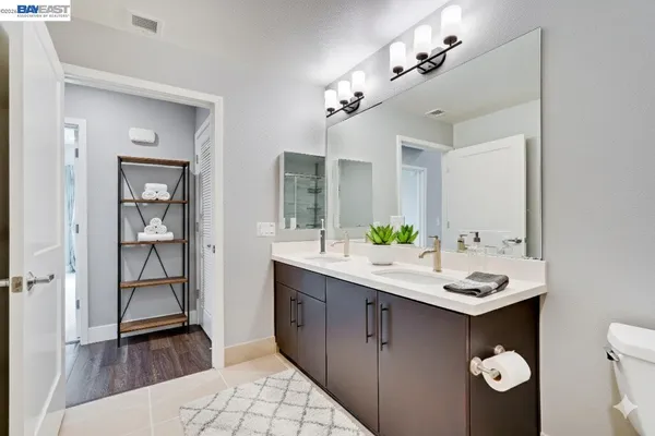 a bathroom with a sink double vanity and a mirror