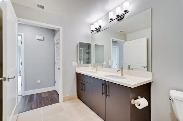 a spacious bathroom with a sink double vanity and a mirror