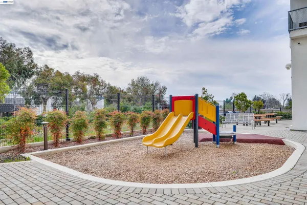 a view of outdoor space with playground and green space