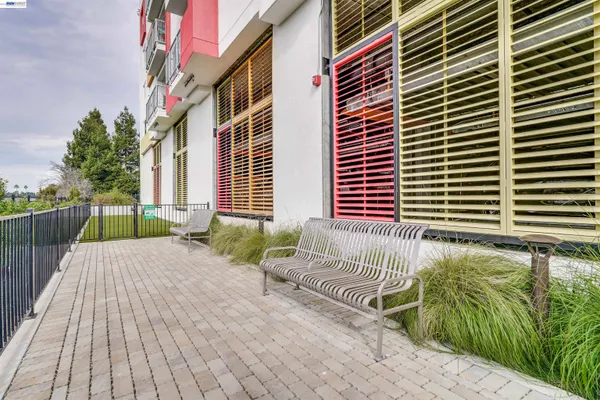 a view of a green field with wooden fence