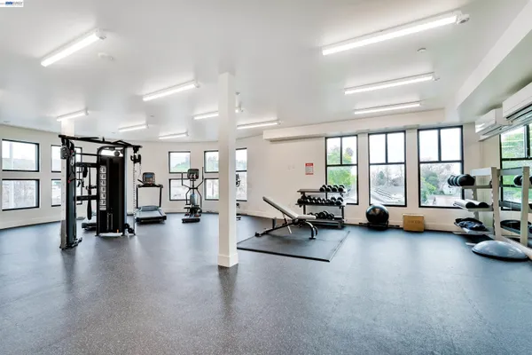 a living room with furniture and floor to ceiling window