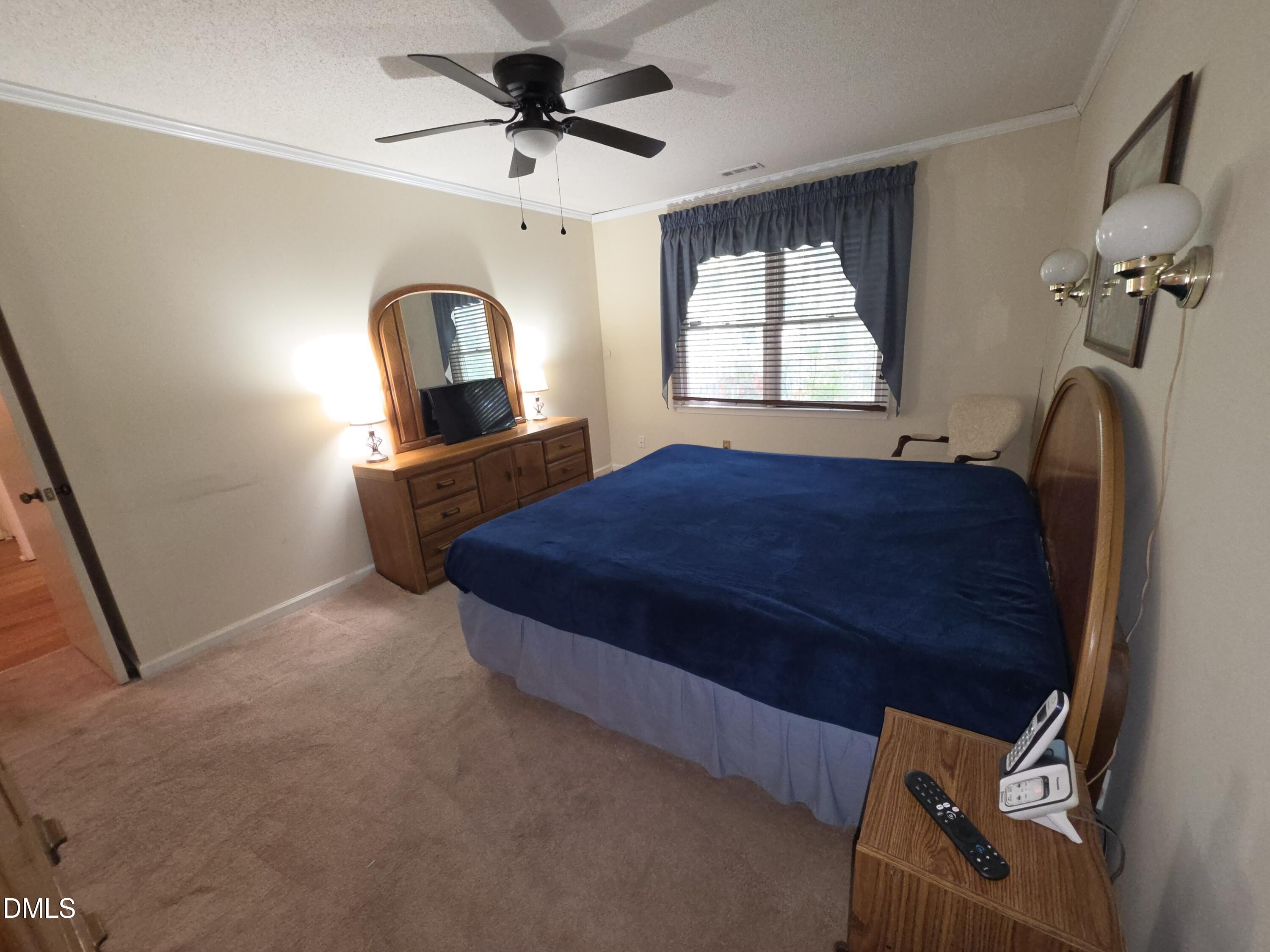 84 Candytuff Lane Durham, NC 27713 - Photo 13 of 23 a bedroom with a bed windows and a chandelier