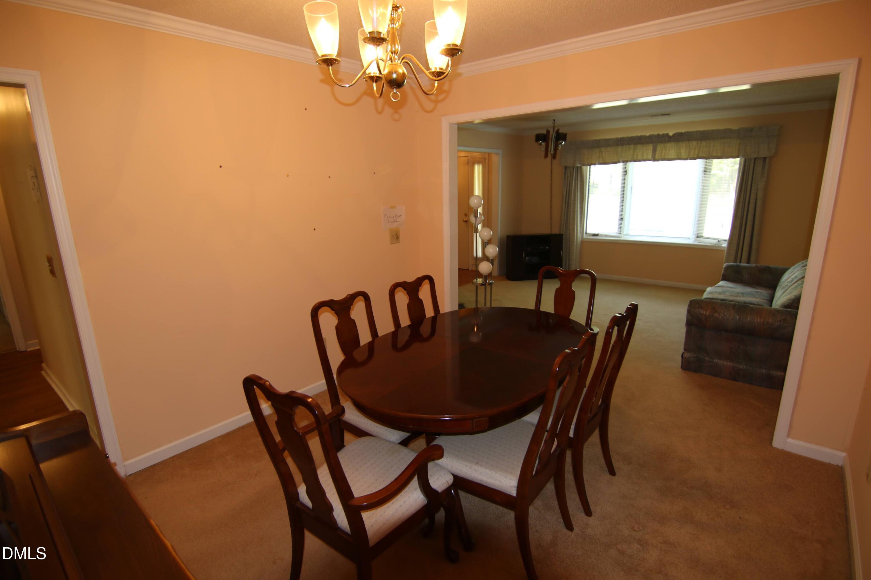 84 Candytuff Lane Durham, NC 27713 - Photo 6 of 23 a view of a dining room with furniture and a chandelier