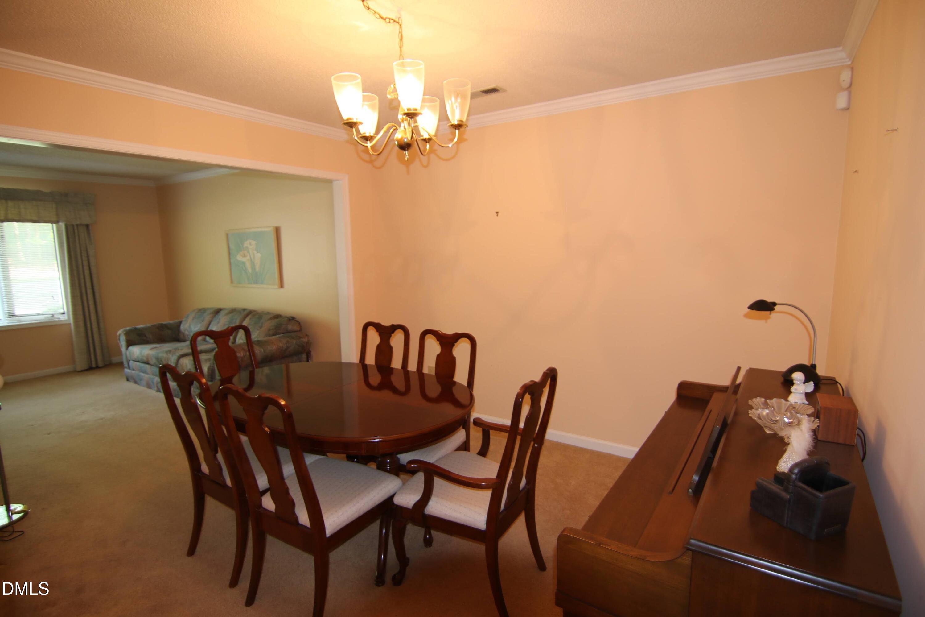 84 Candytuff Lane Durham, NC 27713 - Photo 7 of 23 a view of a dining room with furniture and chandelier