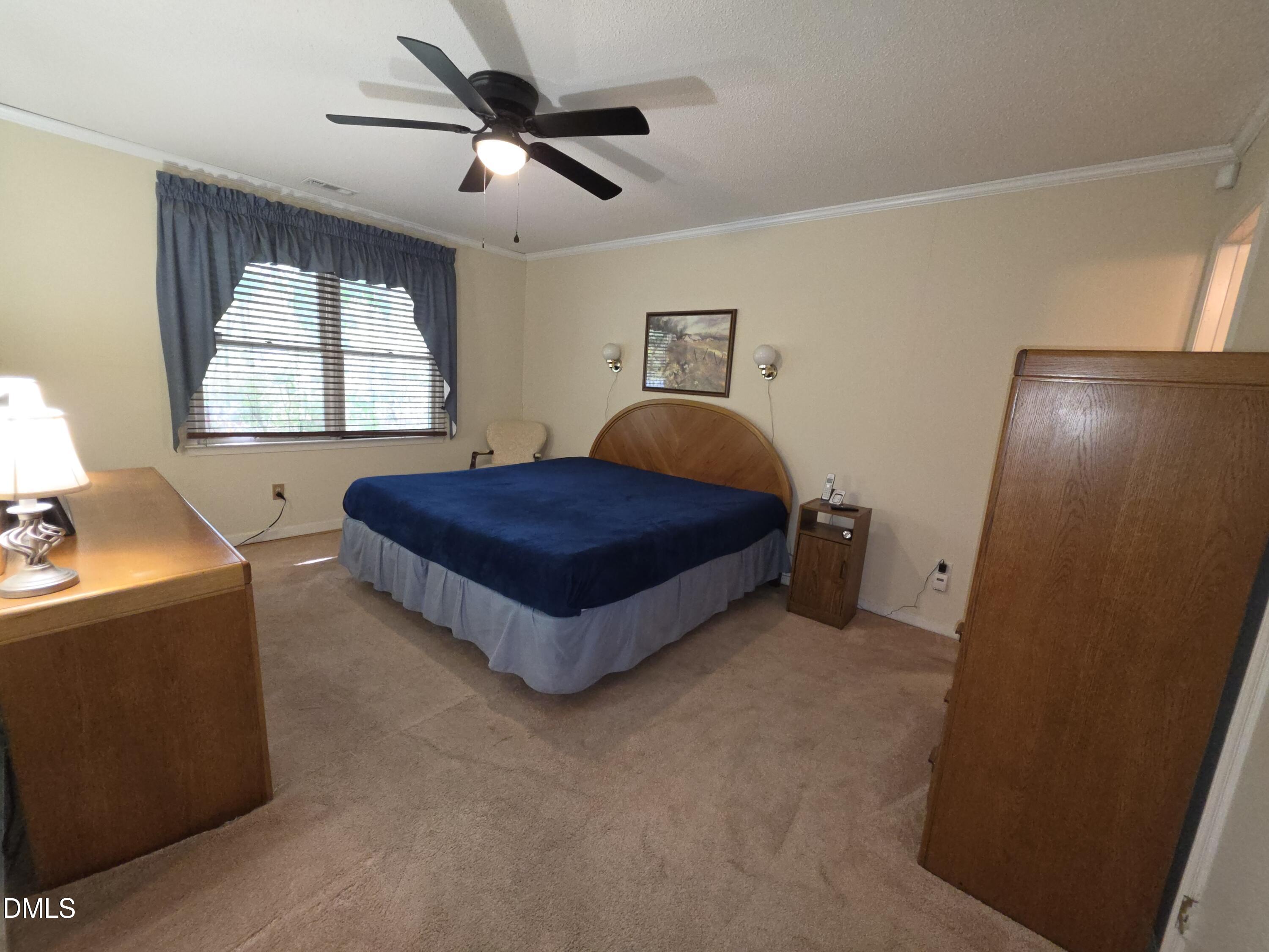 84 Candytuff Lane Durham, NC 27713 - Photo 10 of 23 a spacious bedroom with a bed and window