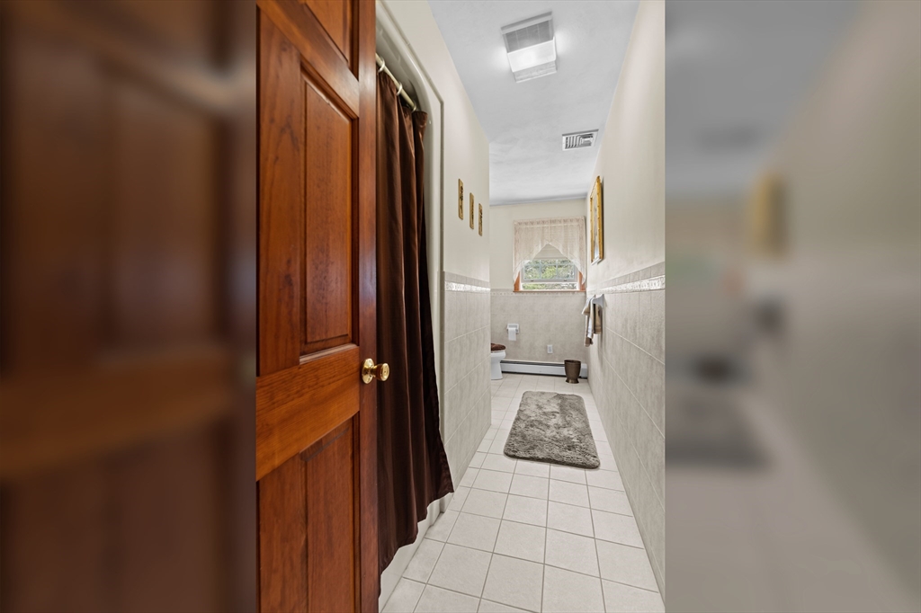 36 High Street Freetown, MA 02702 - Photo 24 of 42 a view of a hallway with a livingroom and a bathroom with sink