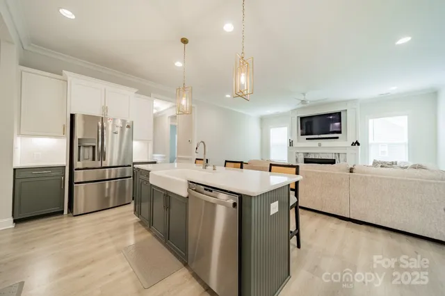 a kitchen with stainless steel appliances granite countertop a refrigerator and a stove