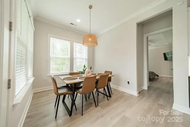 a spacious bedroom with a bed a flat screen tv and windows