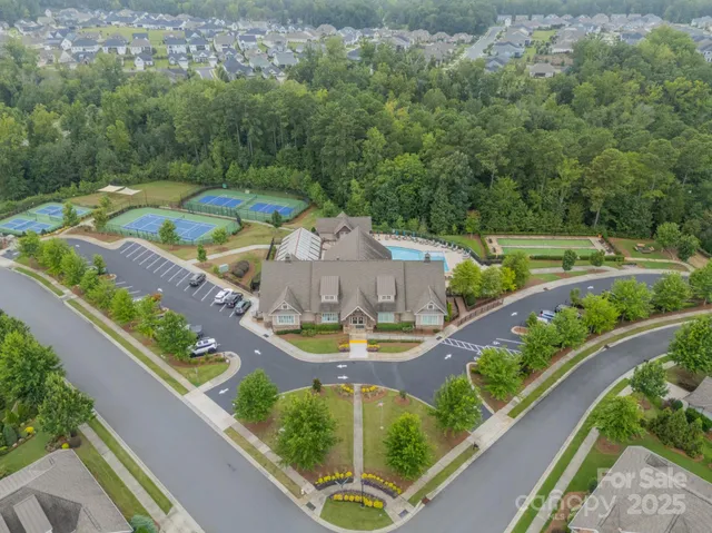 an aerial view of a house with a garden and swimming pool