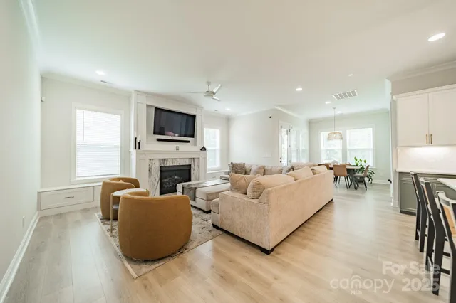 a living room with furniture a fireplace and a flat screen tv