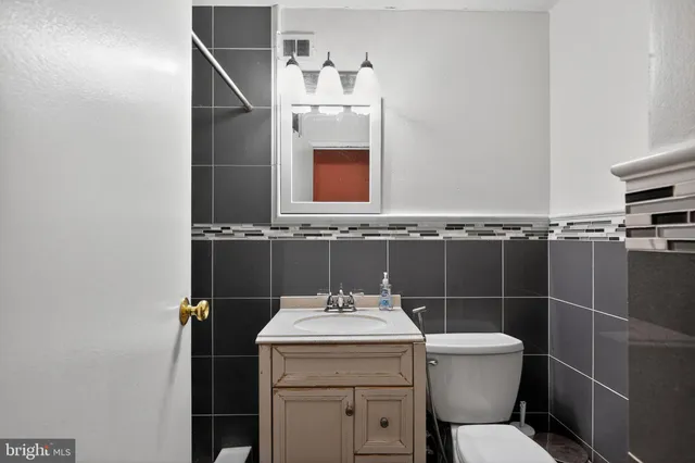 a bathroom with a sink toilet and mirror