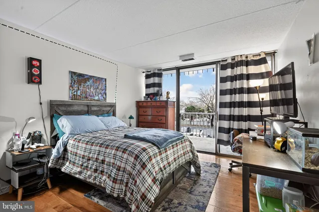 a bedroom with a bed and a desk