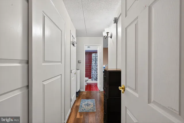 a view of hallway with wooden floor
