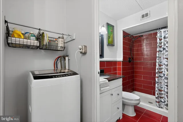 a bathroom with a toilet a sink and glass door