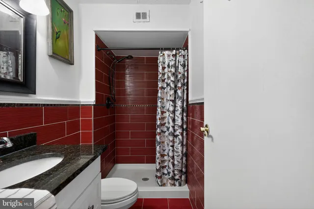 a bathroom with a toilet and a shower