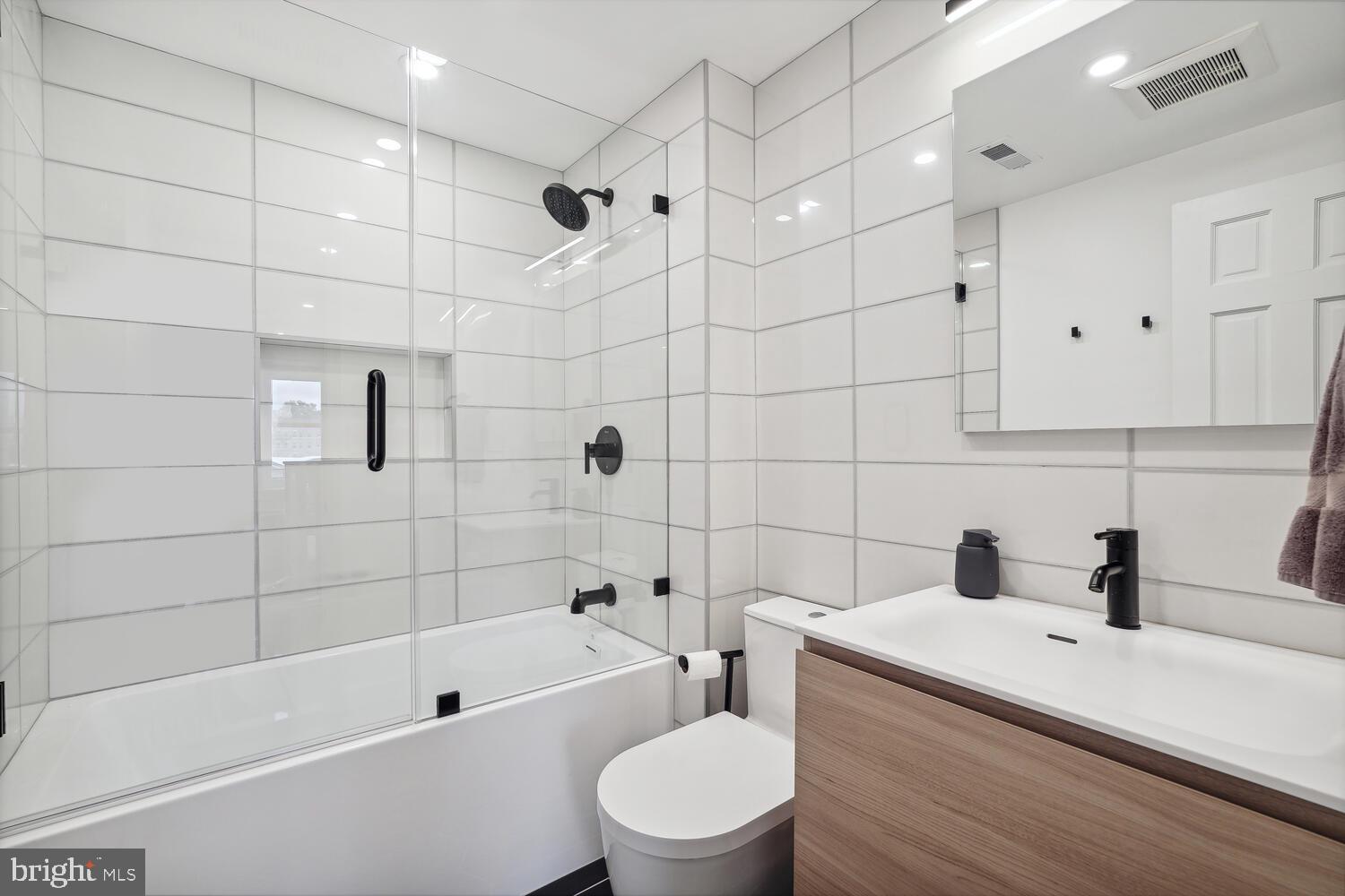 2242 Ontario Road Northwest, Unit 3 Washington, DC 20009 - Photo 13 of 20 a bathroom with a sink a toilet and shower