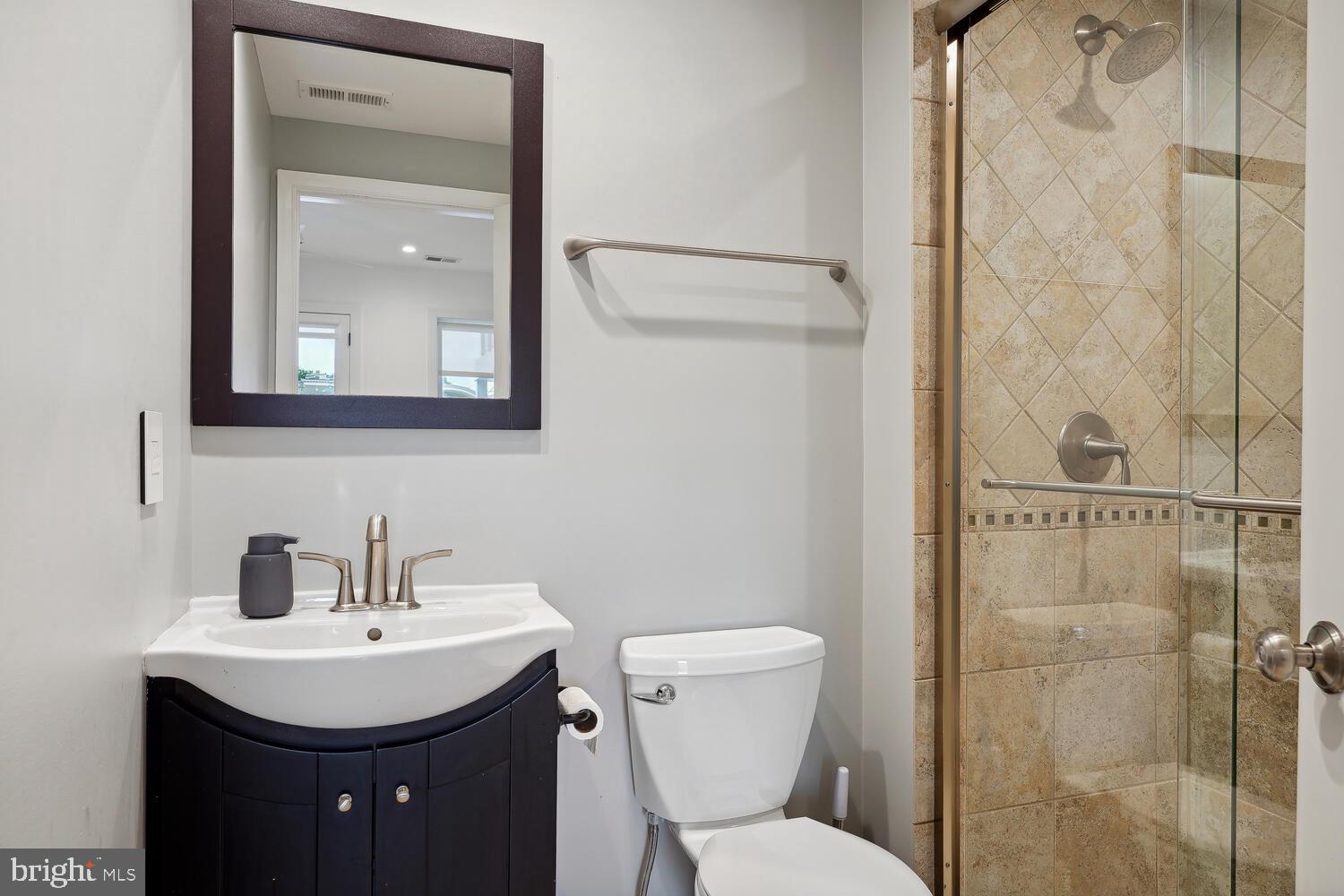 2242 Ontario Road Northwest, Unit 3 Washington, DC 20009 - Photo 16 of 20 a bathroom with a toilet sink and shower
