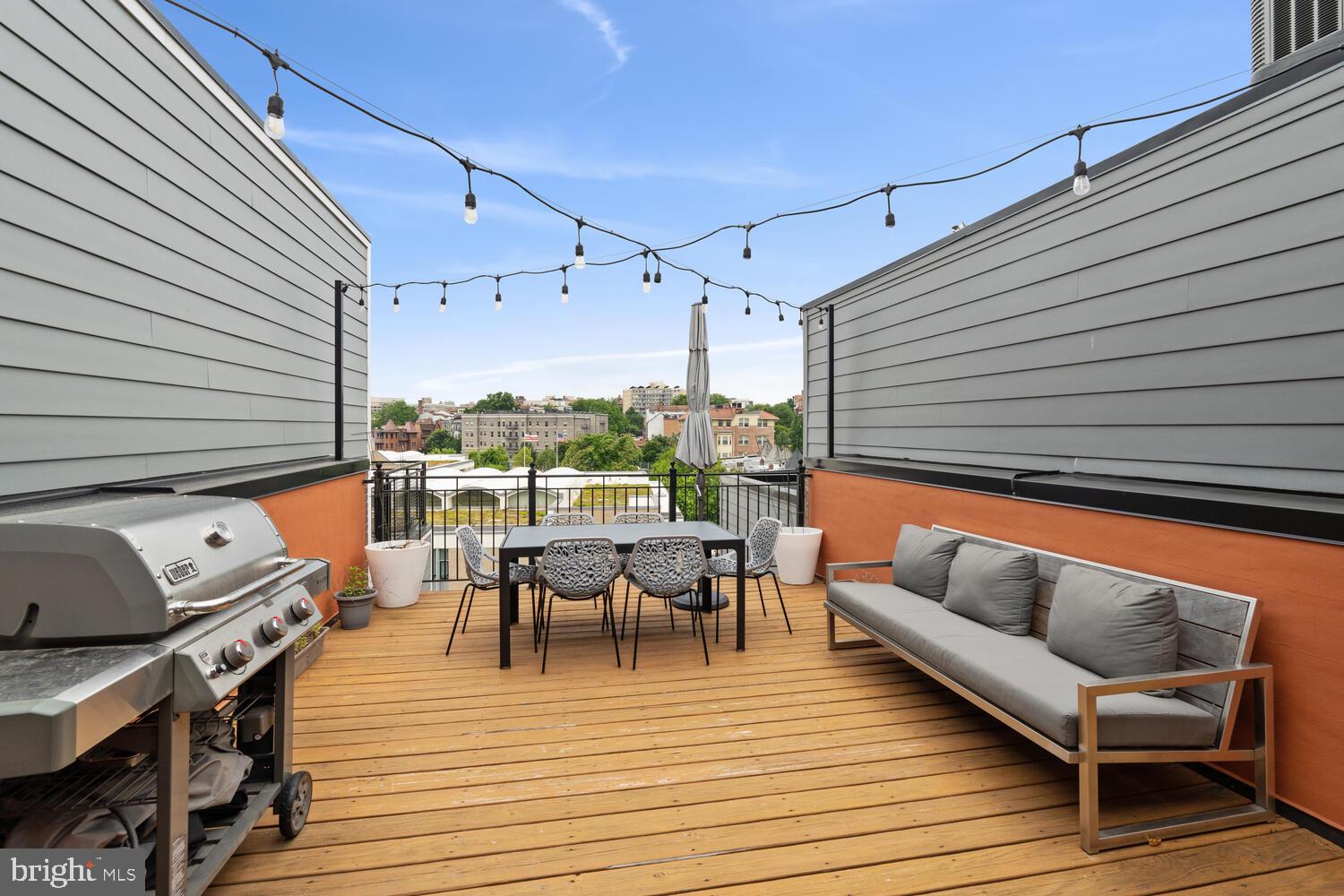 2242 Ontario Road Northwest, Unit 3 Washington, DC 20009 - Photo 19 of 20 a balcony with wooden floor and furniture