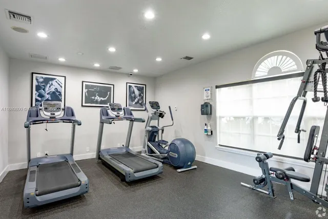 a room with gym equipment and a large window