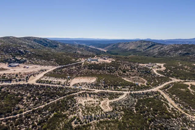 an aerial view of residential house and mountain view in back