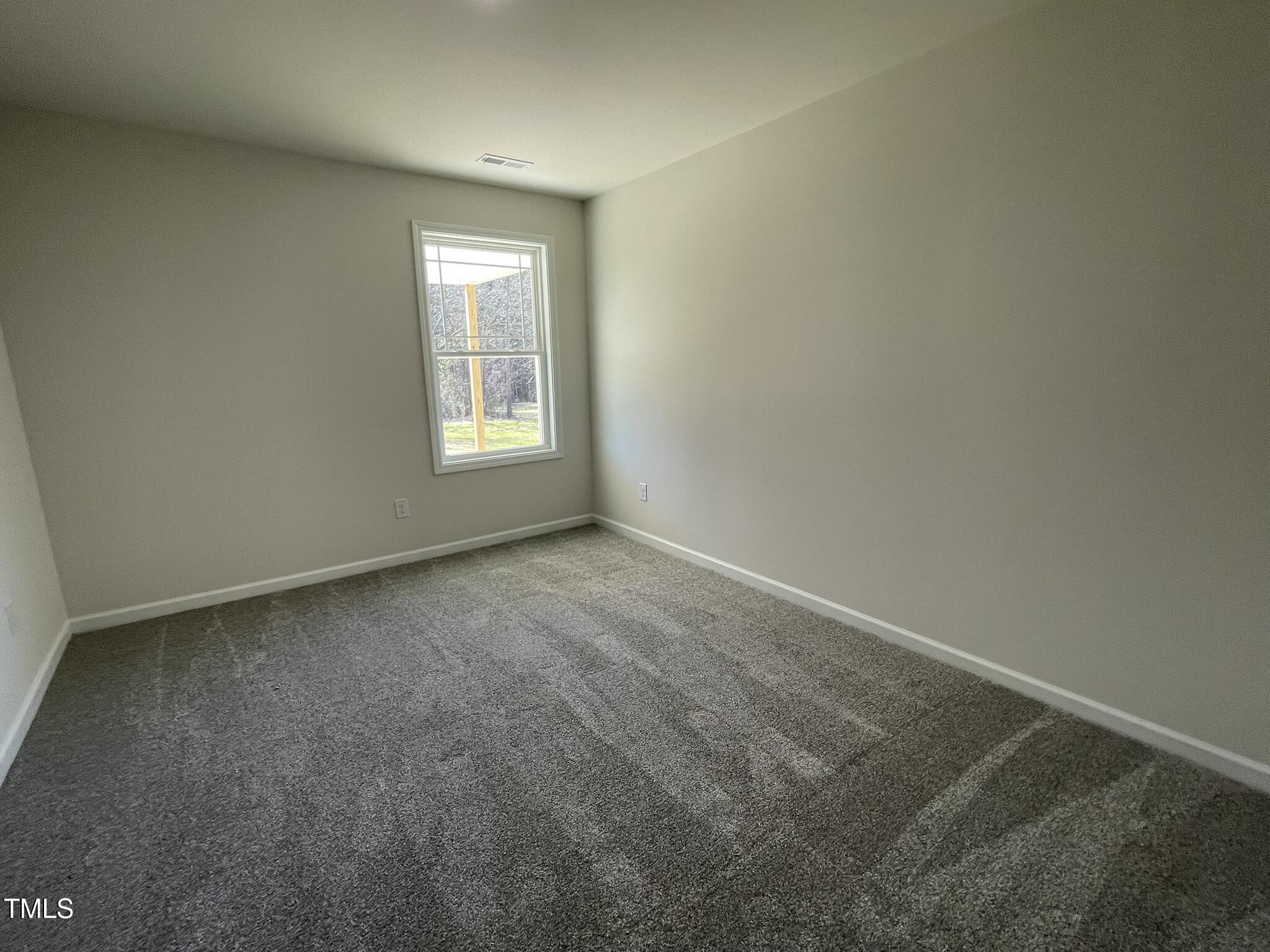 111 Magnolia Run Way Benson, NC 27504 - Photo 13 of 18 a view of an empty room with a window