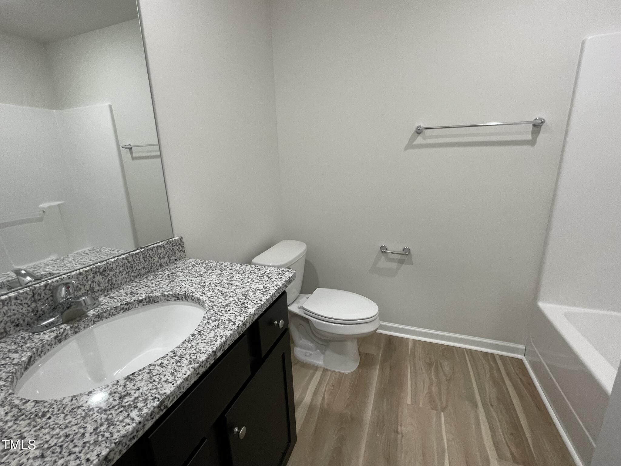 111 Magnolia Run Way Benson, NC 27504 - Photo 14 of 18 a bathroom with a granite countertop sink toilet and shower