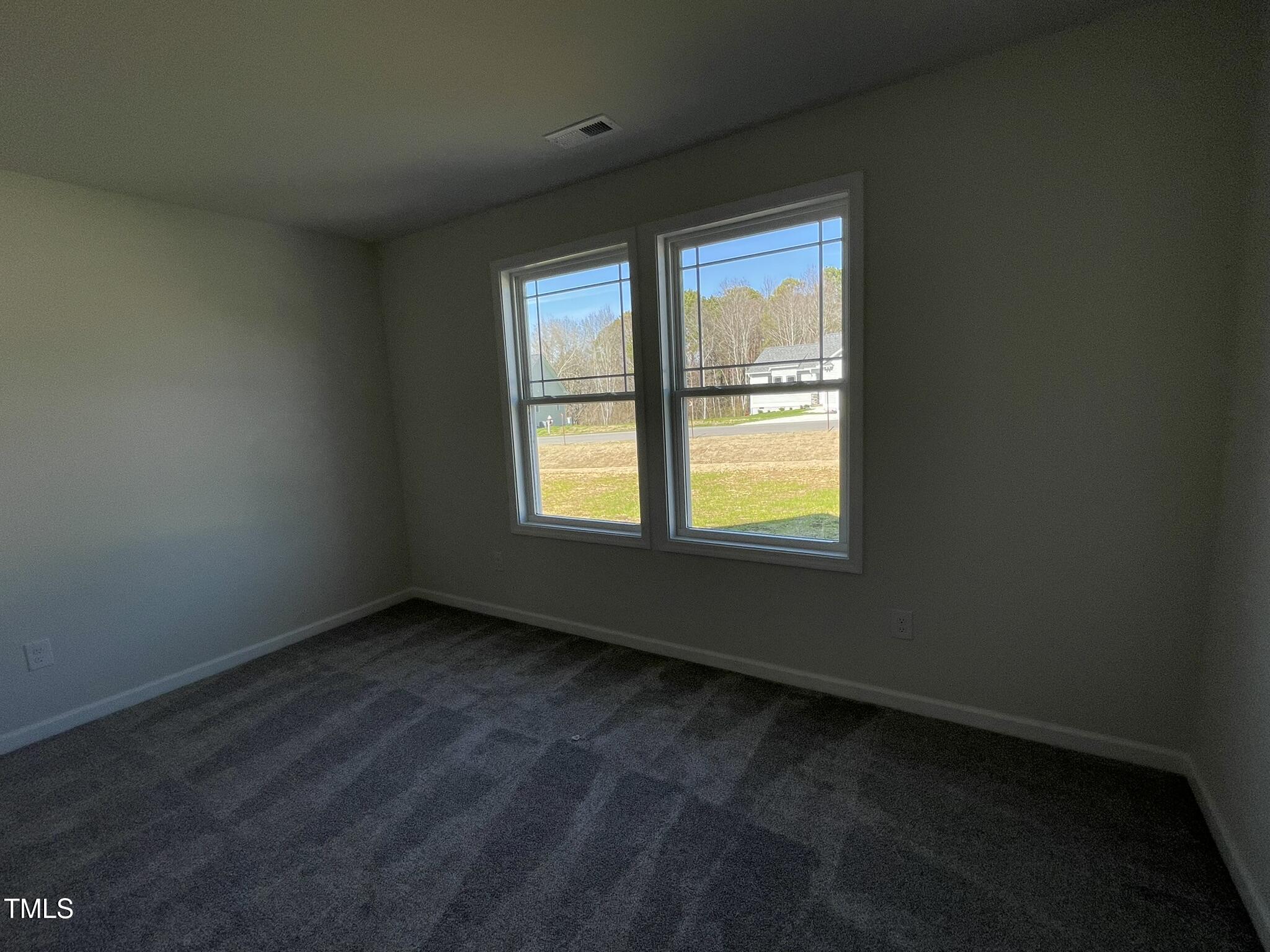 111 Magnolia Run Way Benson, NC 27504 - Photo 15 of 18 a view of an empty room with a window
