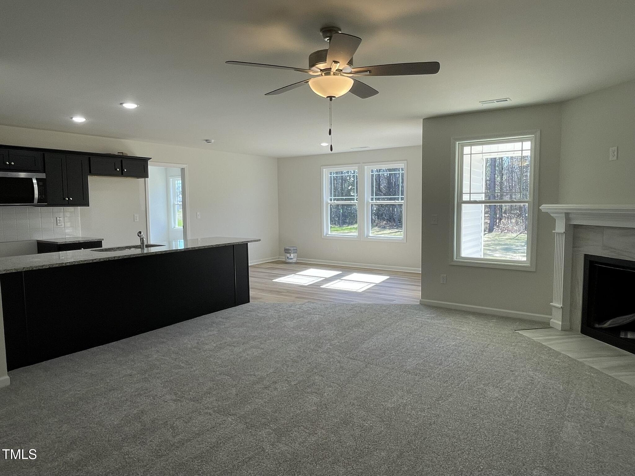 111 Magnolia Run Way Benson, NC 27504 - Photo 3 of 18 a view of kitchen with windows and ceiling fan